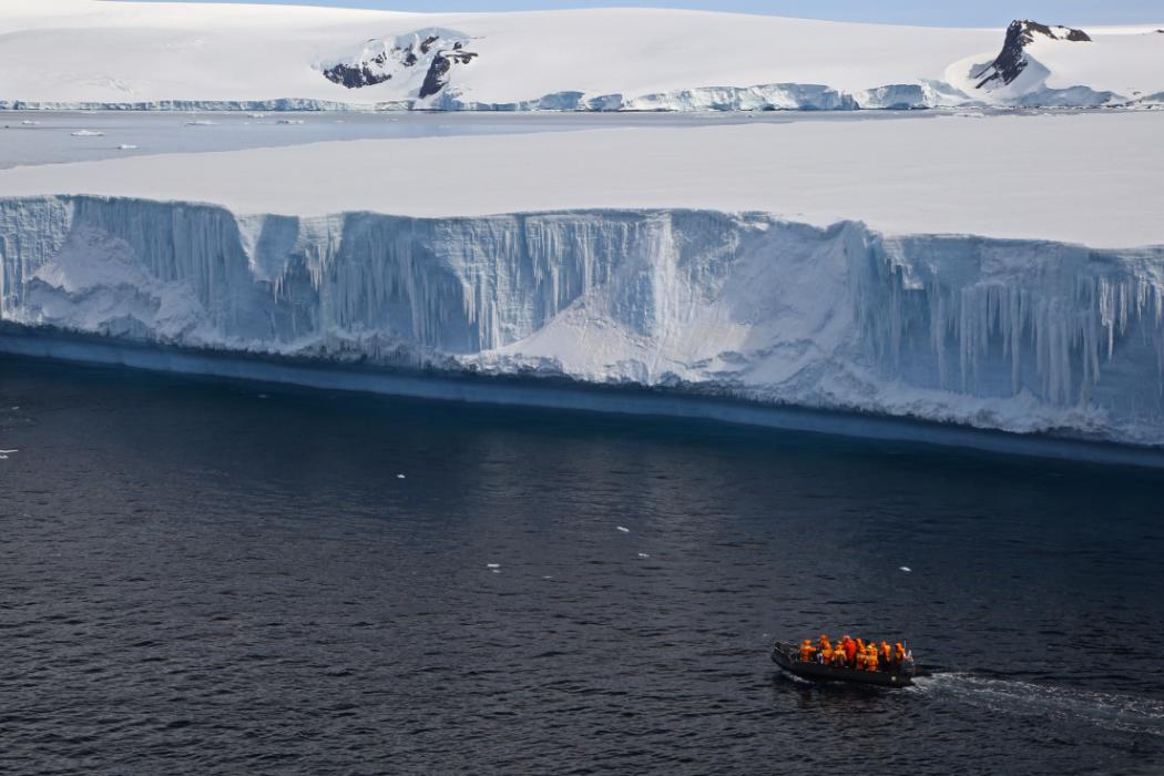 Boatload of researchers near iceberg