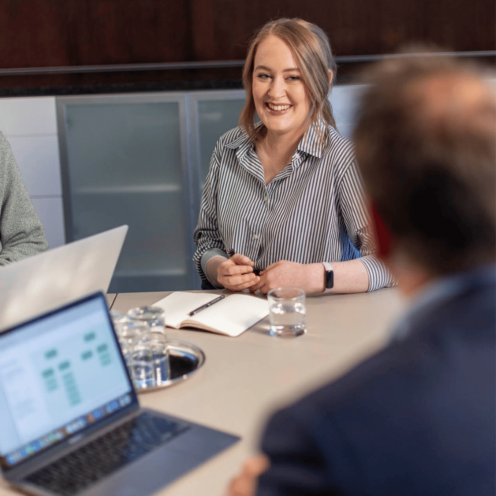 Woman presents her data science findings after graduating from UC Online