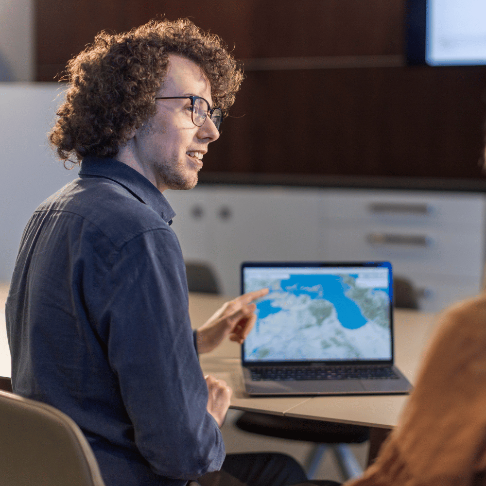 Man presents his data science findings after graduating from UC Online