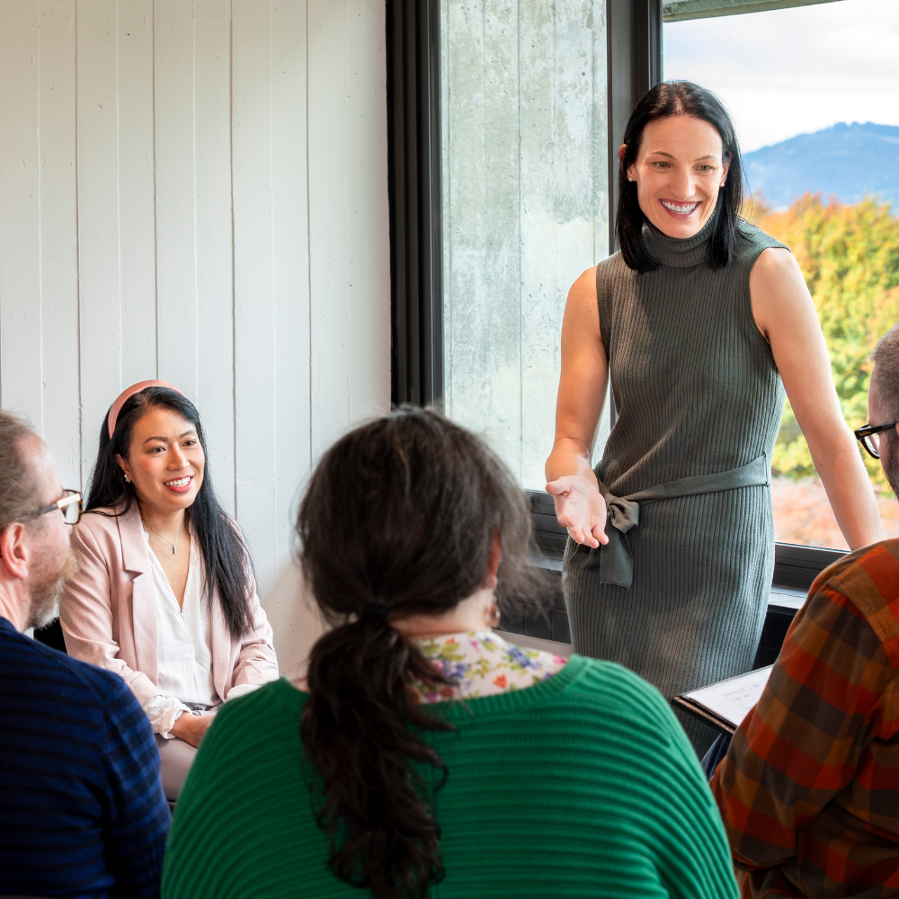 A woman leading a healthcare seminar after graduating with an online bachelor of health from UC Online.