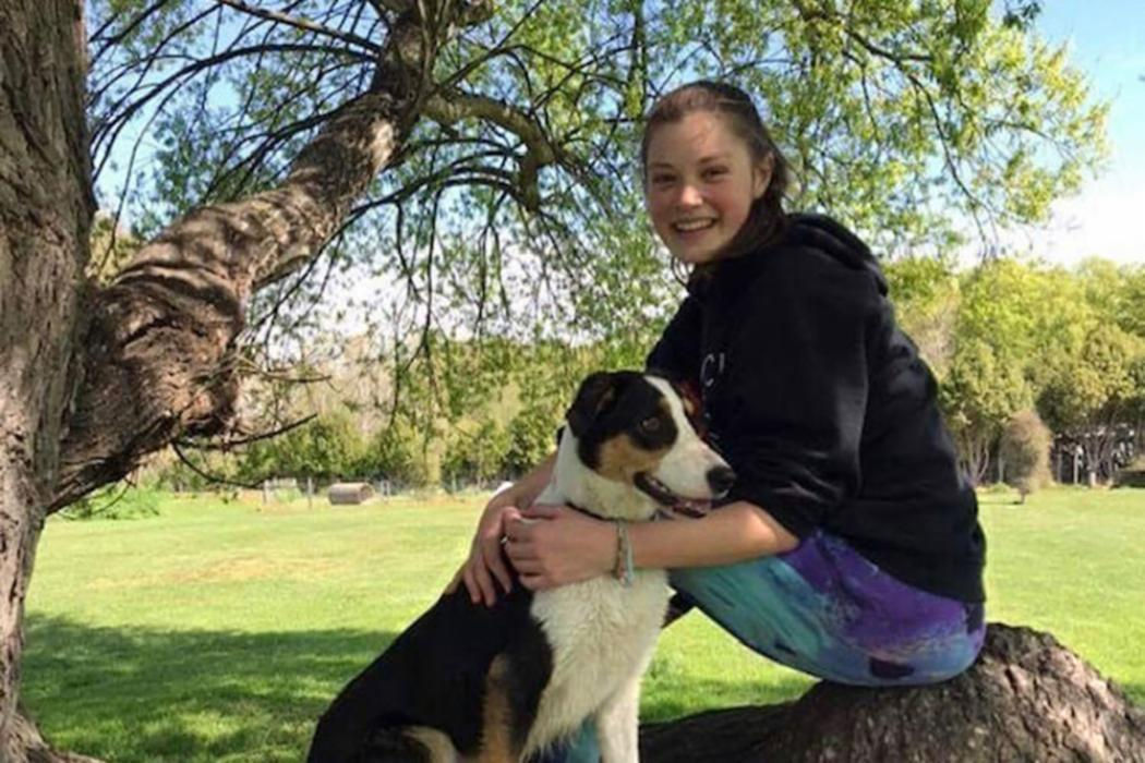 A professional woman greets UC Online team members before a meeting about staff training and development options.