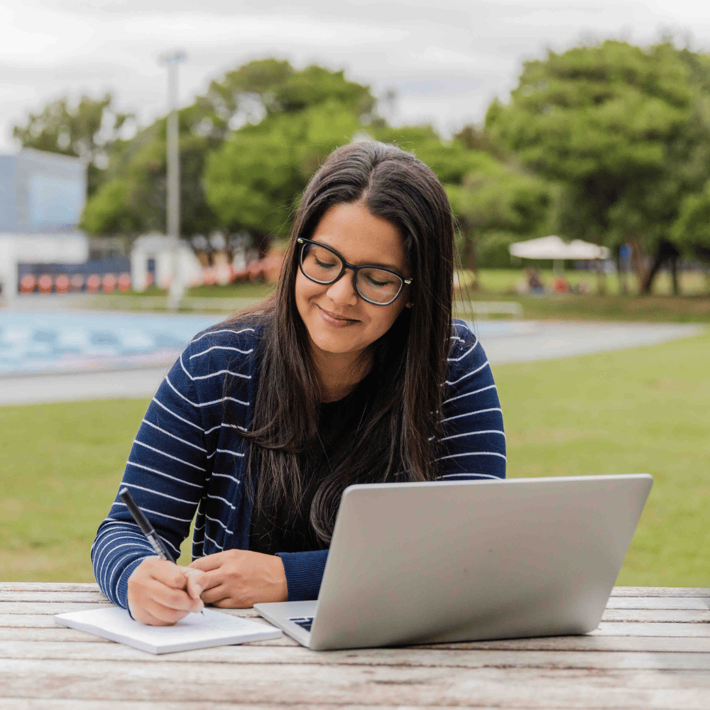 Woman studying sustainability outside with flexible online courses