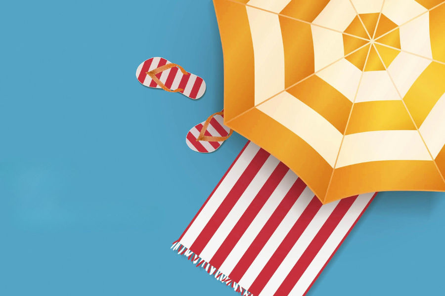 Top-down view of a summer umbrella and beach towel with jandals.