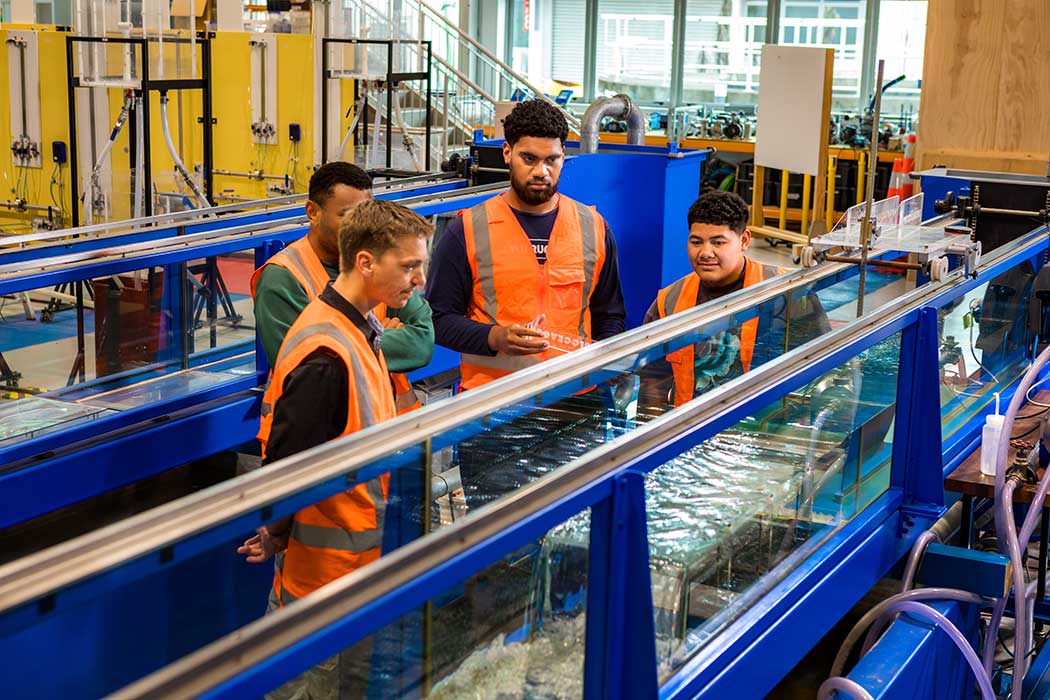 UC student Apisalome doing a flow test in the UC Fluids Lab with other Engineering students.