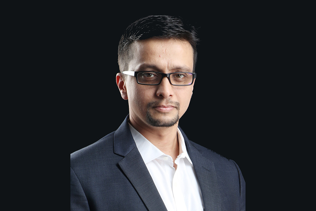 UC graduate Ram Iyer before a neutral background.