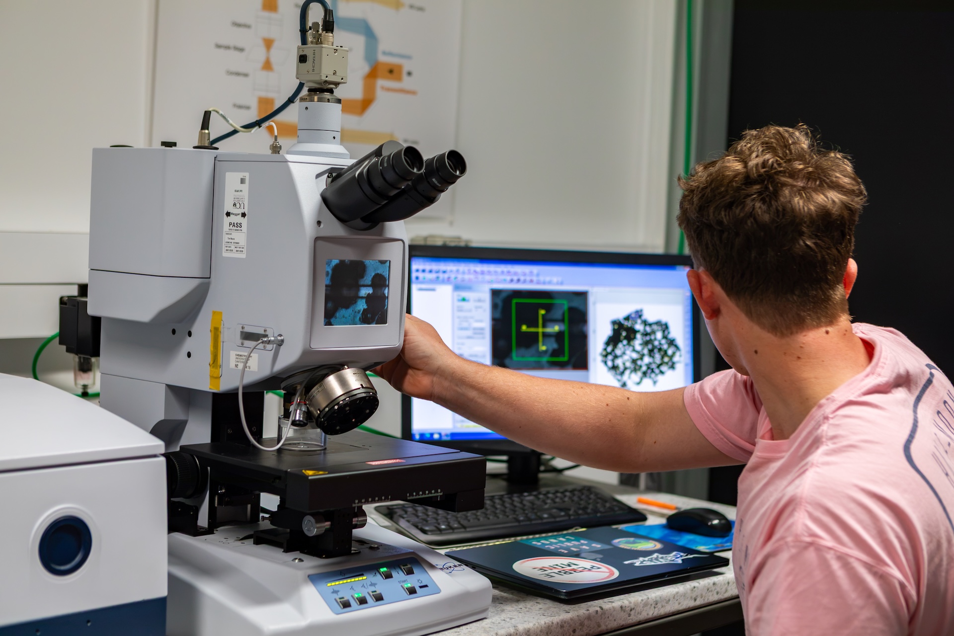 Researcher using a Microscope Fourier Transform Infared Microscope.