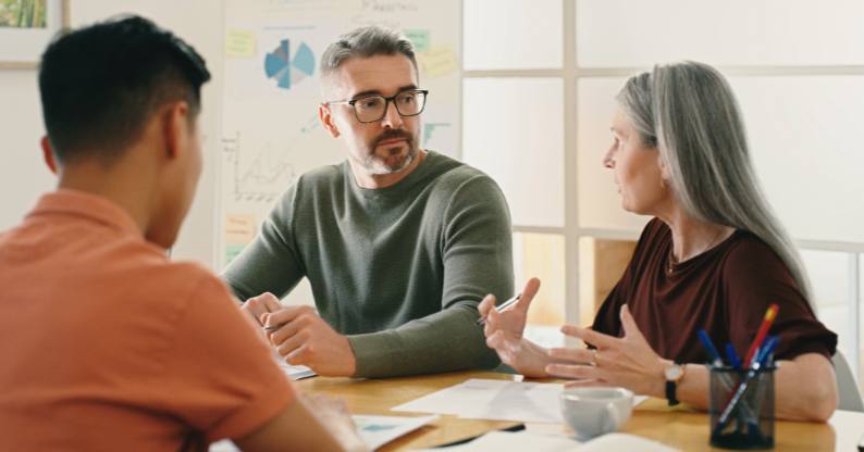 Three project managers discussing work as part of their online Professional Project Management online course with Tuihono UC | UC Online