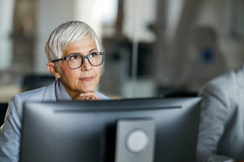 Women looking into the distance while working at her computer