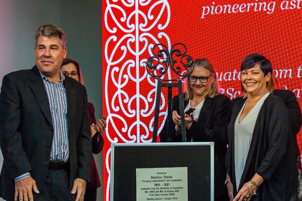 Alan (pictured front left) and Teresa Tinsley (pictured right) unveil the plaque that will adorn the building named for their mother, astronomer Beatrice Tinsley.