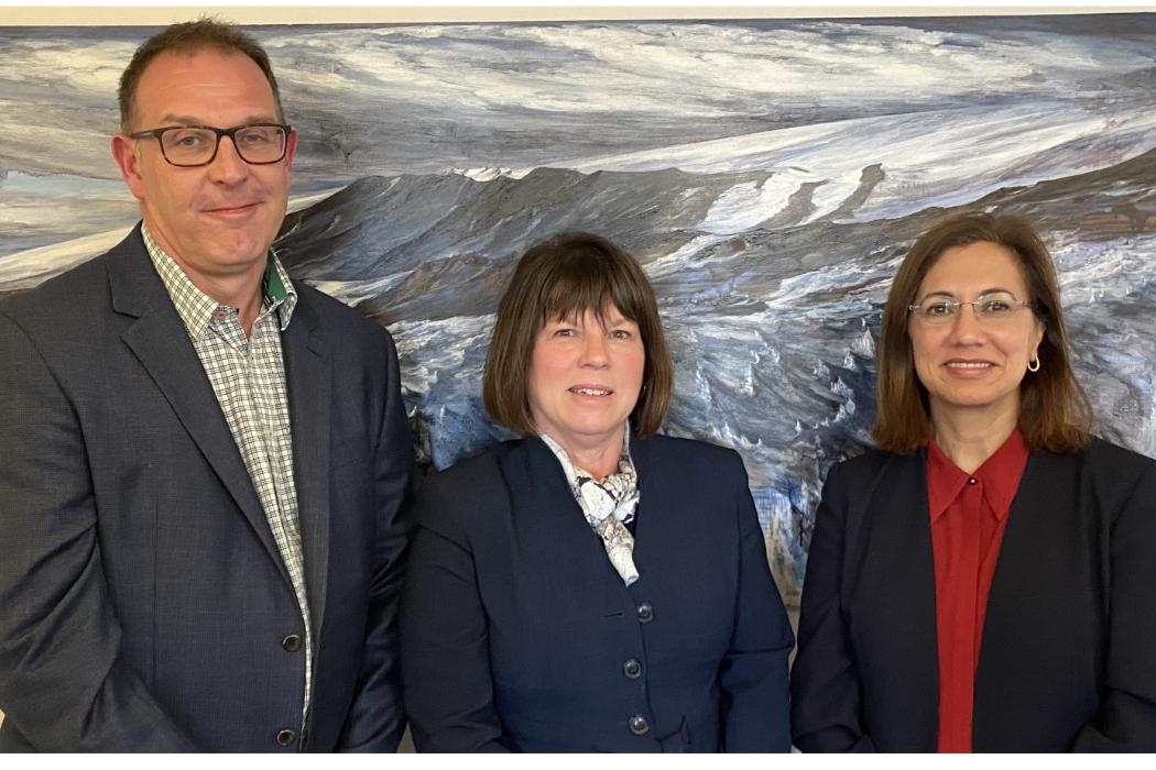 L-R: University of Canterbury (UC) Gateway Antarctica Director Professor Adrian McDonald, COMNAP Executive Secretary Michelle Rogan-Finnemore, and University of Canterbury Vice-Chancellor Professor Cheryl de la Rey in front of an original artwork by Margaret Elliot, a New Zealand artist with close ties to Gateway Antarctica.