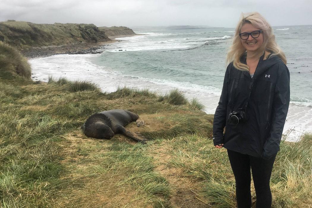 Alexa Hasselman at Waipapa Point lighthouse with New Zealand sea lion