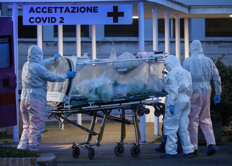 A coronavirus patient being transported to hospital in Italy. EPA 