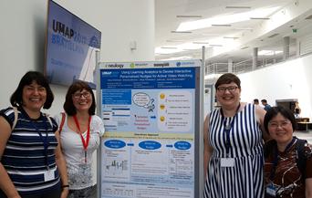University of Canterbury AVW Space Team  at tht UMAP 2017 Conference standing next to an information banner