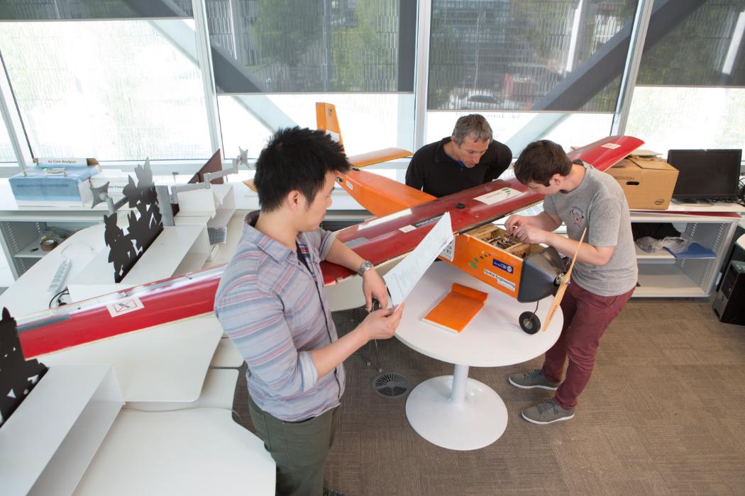 Students and Supervisor Working on Plane