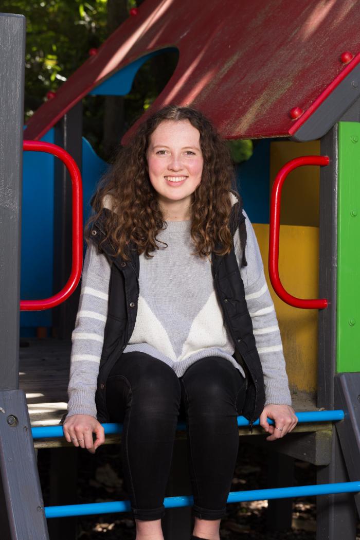 student sitting on a childrens playground