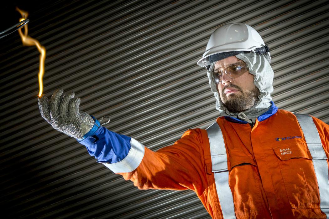 Man-in-safety-gear-demonstrates-electrical-arching-Facilities