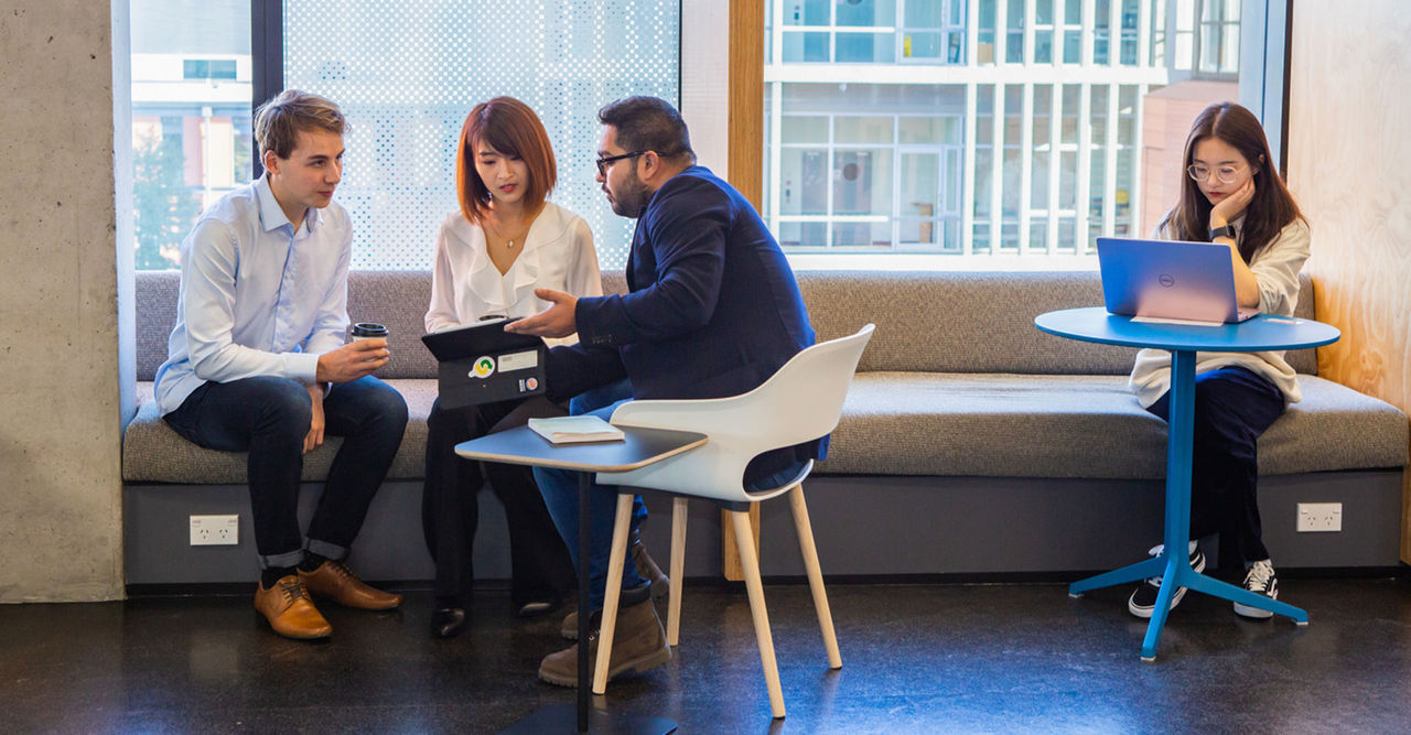 Group of Business students studying A group of Business students studying on campus in a window seat.