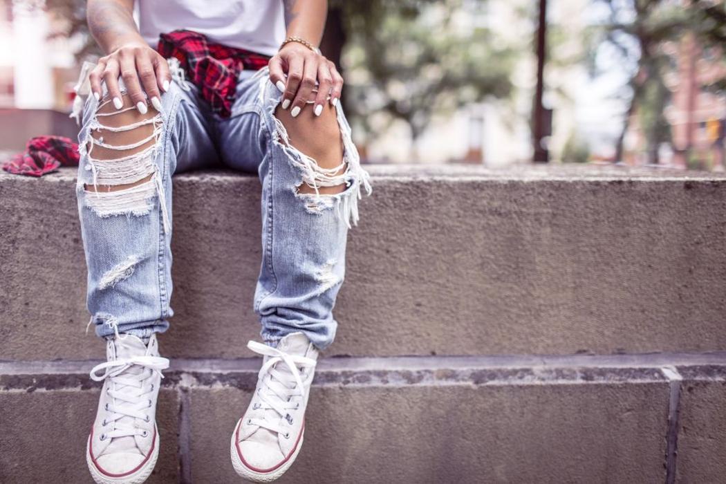 Bottom Half Shot of a Young Person Sitting on a Low Wall