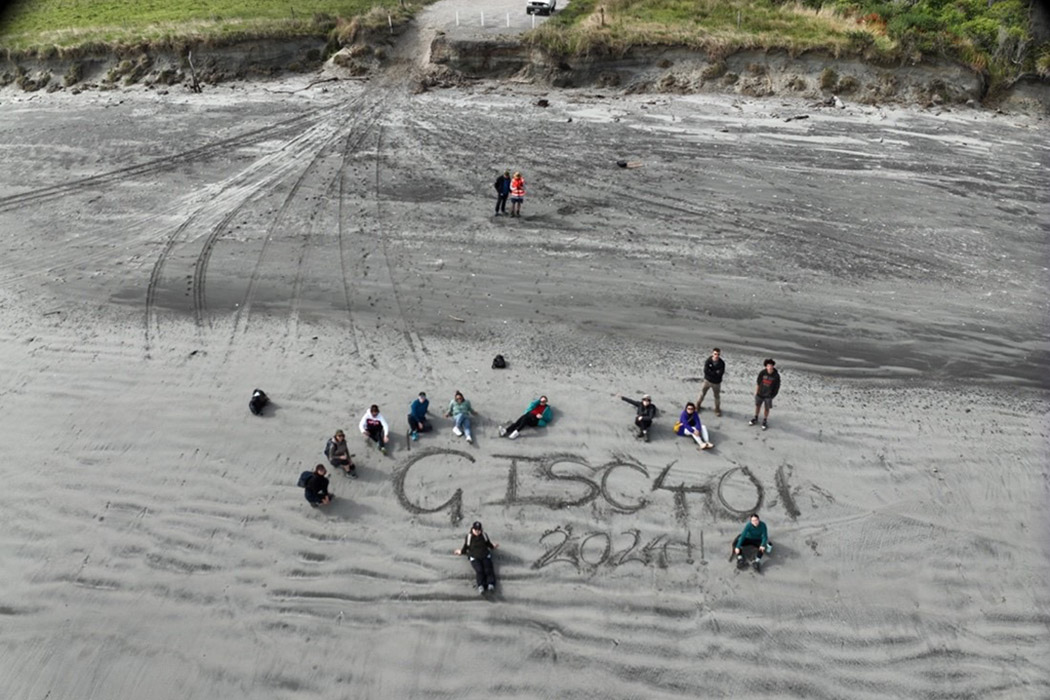 Aerial view of GISC401 field trip students on a beach