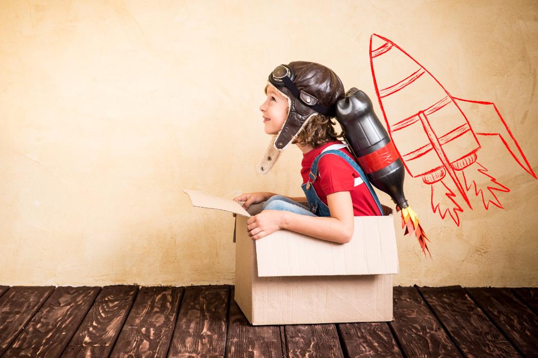 Child playing Imaginary Game Sitting in Box