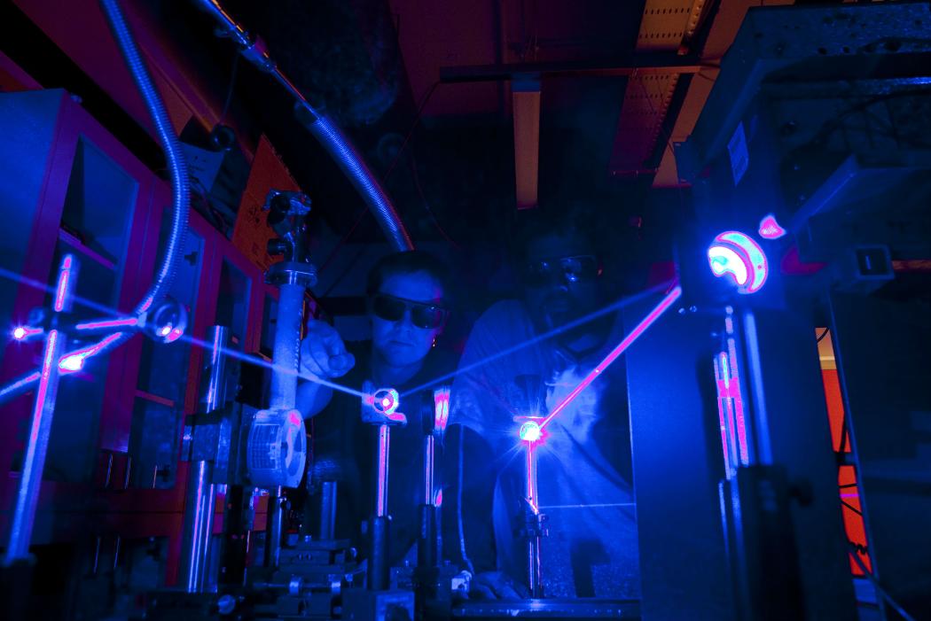 students in physics lab with laser