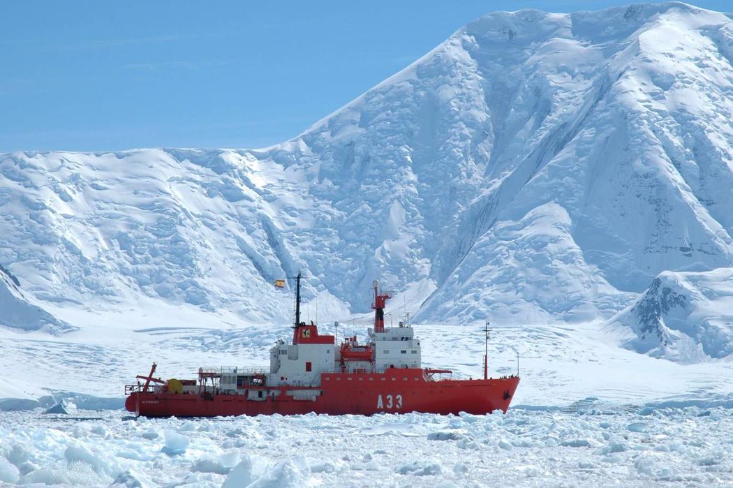 ship cutting through ice floes in antarctica