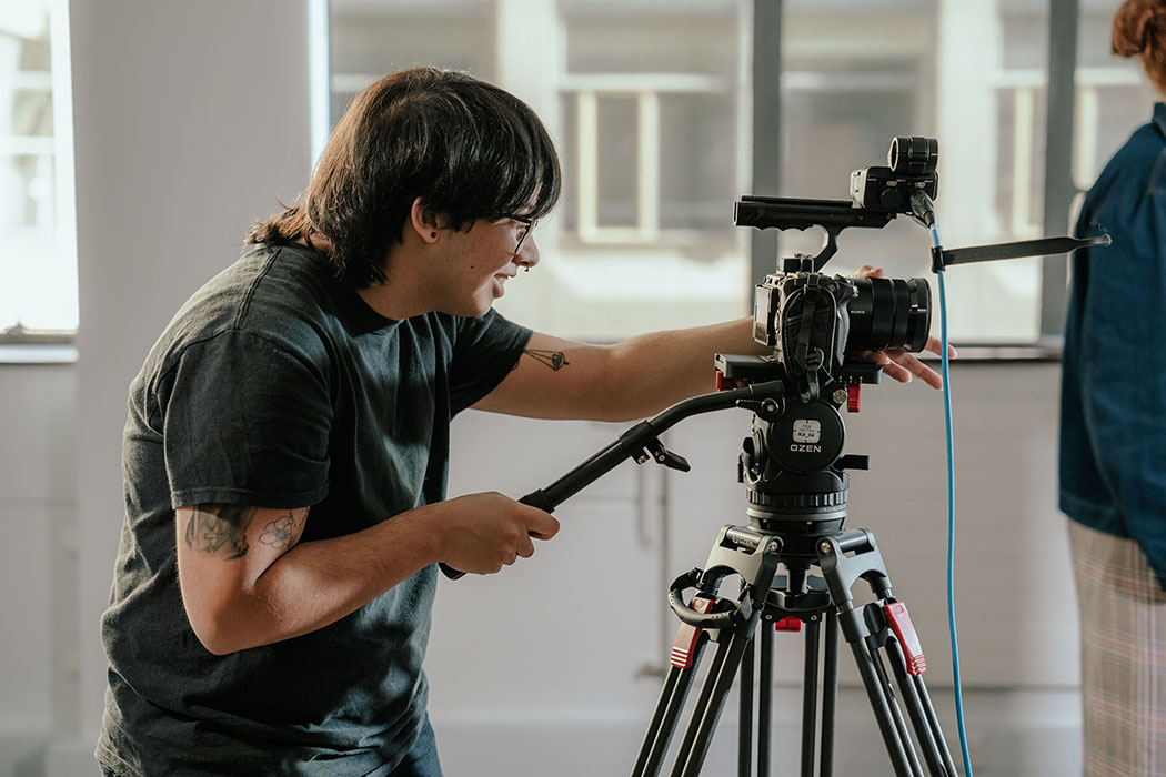 UC student working with a film camera.