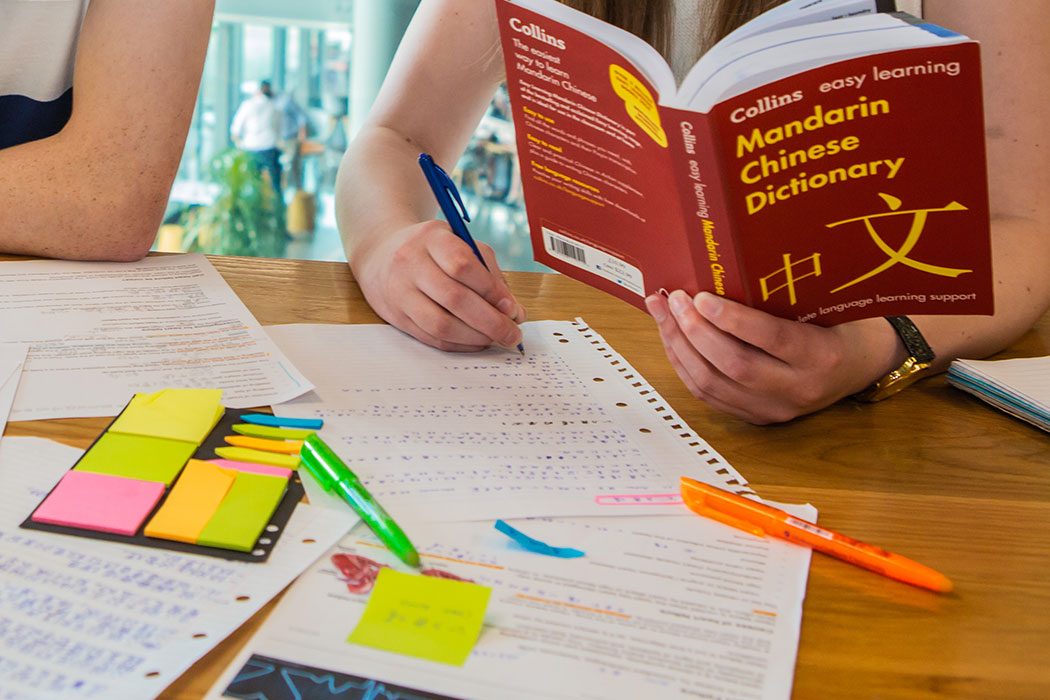 UC MATI students translating text from English to Mandarin.