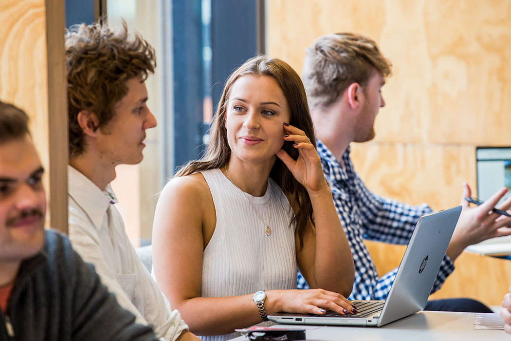 UC Business students mentoring during a business class.